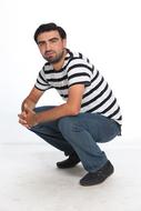 handsome stylish man squatting