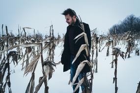 young Man on corn Field at winter