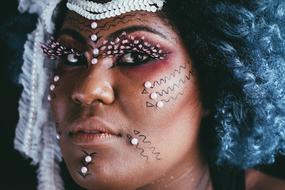 photo of a dark-skinned woman with ritual makeup