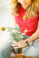 Smiling, blonde woman with the colorful and beautiful flowers