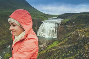 adult woman in view of scenic Waterfall