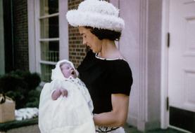 retro photo of woman holding baby in her arms