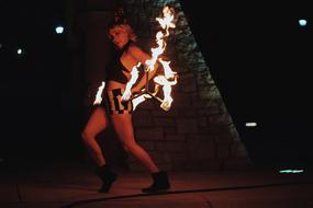 Fire Dance, young woman with flame at night