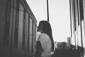 Black and white photo of the woman among buildings