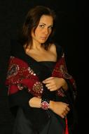 serious young girl in black dress and red scarf