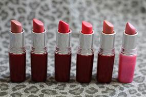 lipsticks in a row close-up on a blurred background