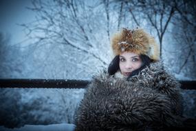 young Girl in fur winter clothing at snowy landscape