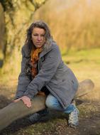woman posing on the tree trunk
