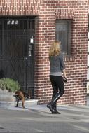 woman walking with a dog in the city