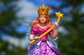 Fairy with magic wand, colorful figurine