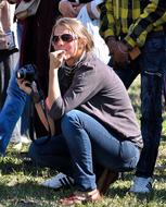 Blonde woman photographer on the grass