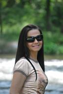 Brunette woman with the glasses at background with the plants