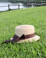 Fashion straw Hat on grass at water