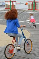 Woman and child girl Cycling on track