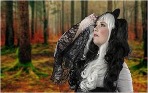 photo of a girl with black-white hair on a background of autumn forest