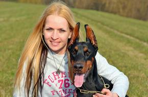 Blonde Woman with Doberman dog outdoor