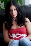 brunette in a red shirt on the couch