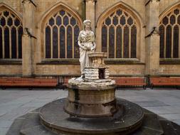 statue of a woman with a fountain in england