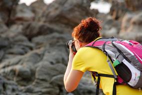 red-haired girl photographs mountains