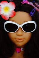 Portrait of the girl doll with white sunglasses and colorful and beautiful dlowers