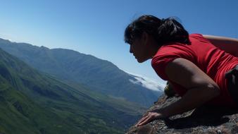 girl is watching from the top of the mountain