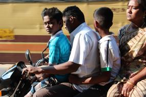 indian family on Motorcycle, parents and two child boys