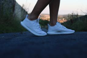 person walks in Fashion white sneakers
