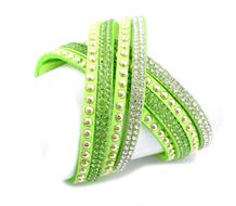 green bracelet with beads on a white background