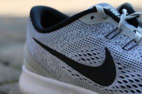 macro photo of gray nike sneakers