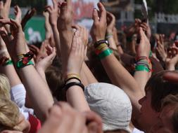 people with hands up at the festival