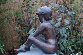 bronze sculpture of a sitting girl
