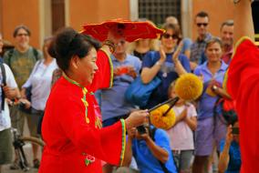 dancing Cinese woman with sticks