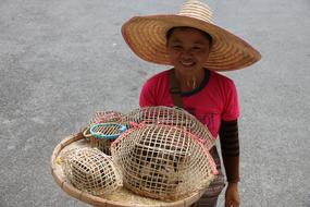 Thai Woman with Birds in weaved cages on tray