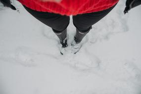 Top view of the women with boots in snow