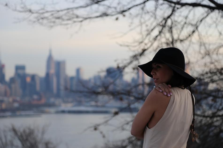 young girl in black hat in view of new york city