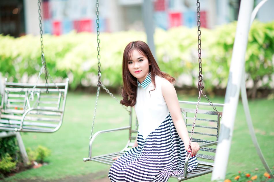 asian lady on swing in the park