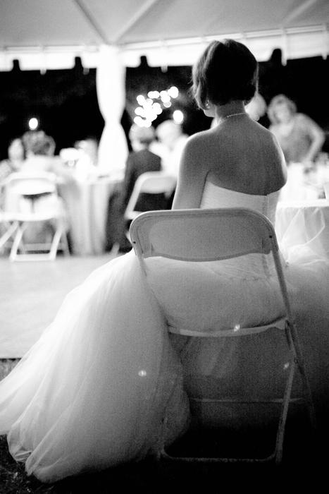 Bride in Wedding dress sits on chair