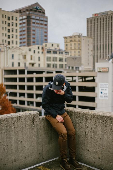 Photo of man on the edge of a roof