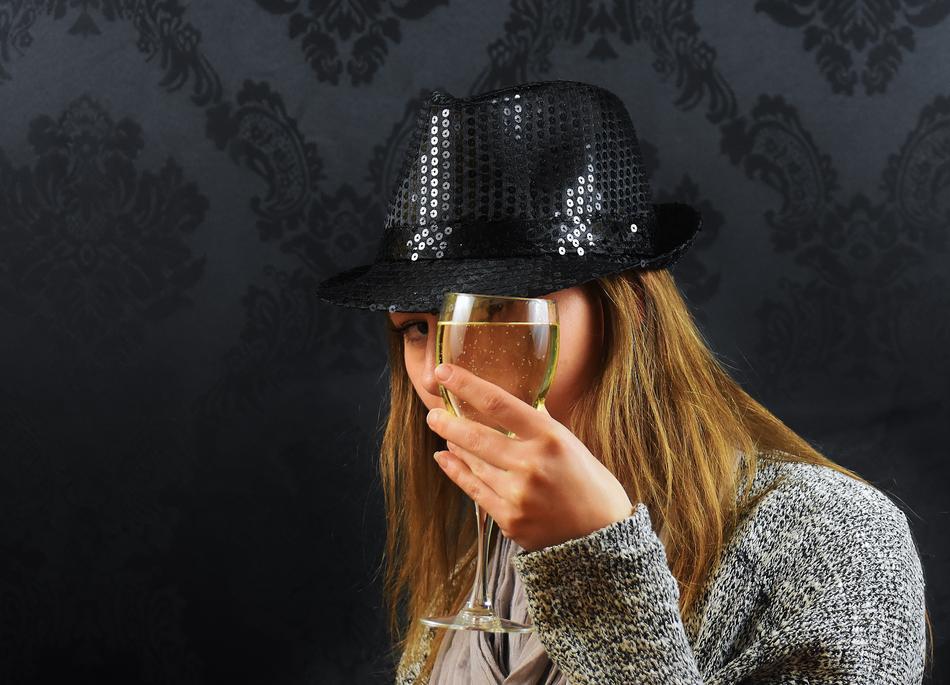 Woman with black Hat holding Champagne