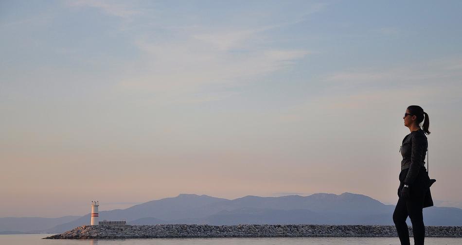 Woman on coast at sunrise