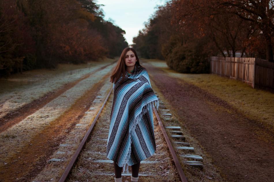 Woman walking on railway in countryside