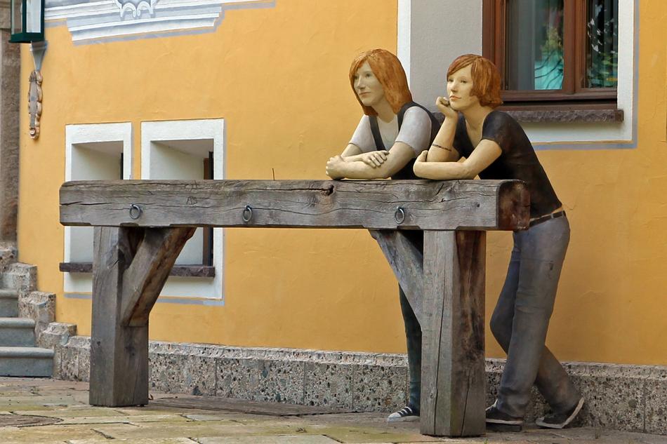 sculptures of redhead women waiting
