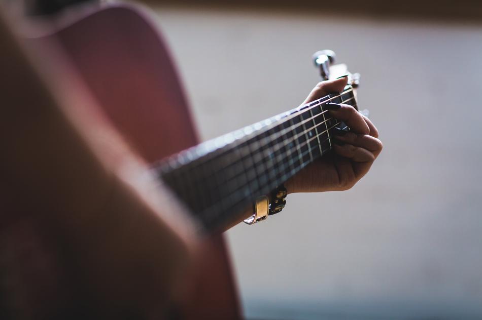 playing guitar in blurred background