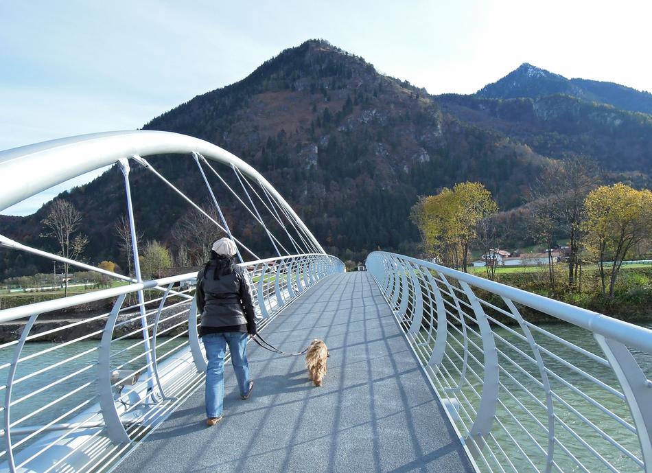 woman with a dog on the bridge