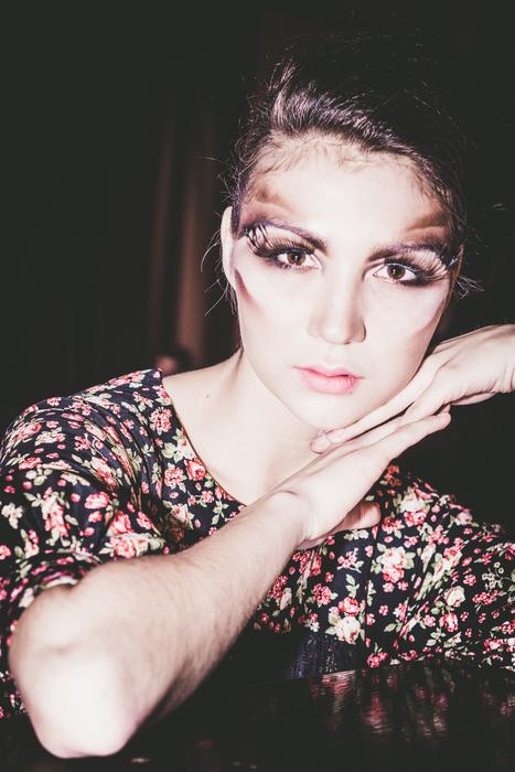Portrait of the beautiful, posing girl on the hands, in colorful dress