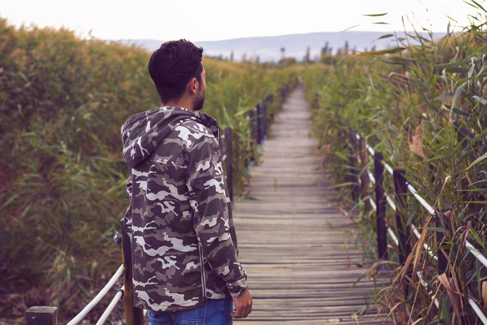 guy on the wooden path among the reeds