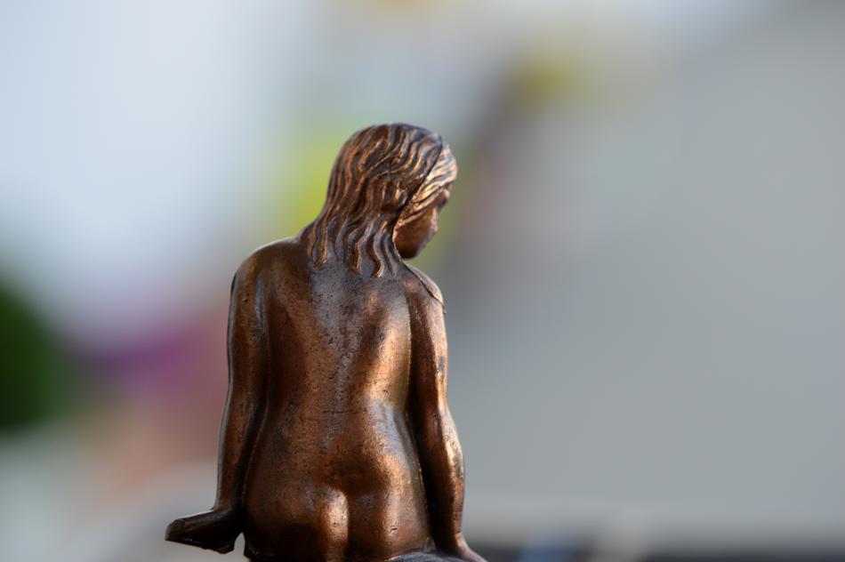 Back view of the beautiful, shiny statue of the woman