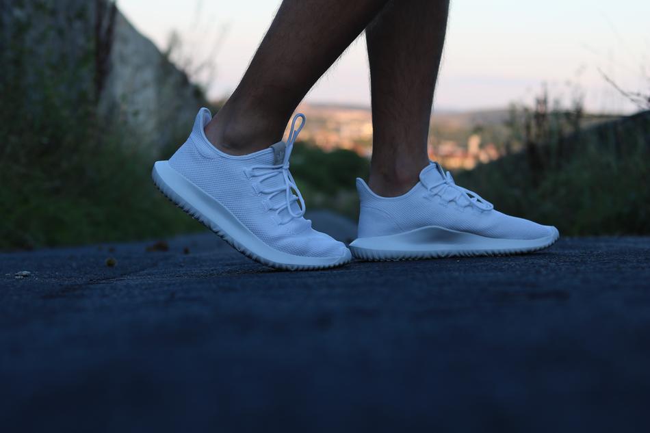 person walks in Fashion white sneakers
