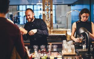 woman and man preparing drinks in the kitchen