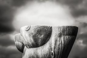 Marble sculpture of a woman on a blurred gray background